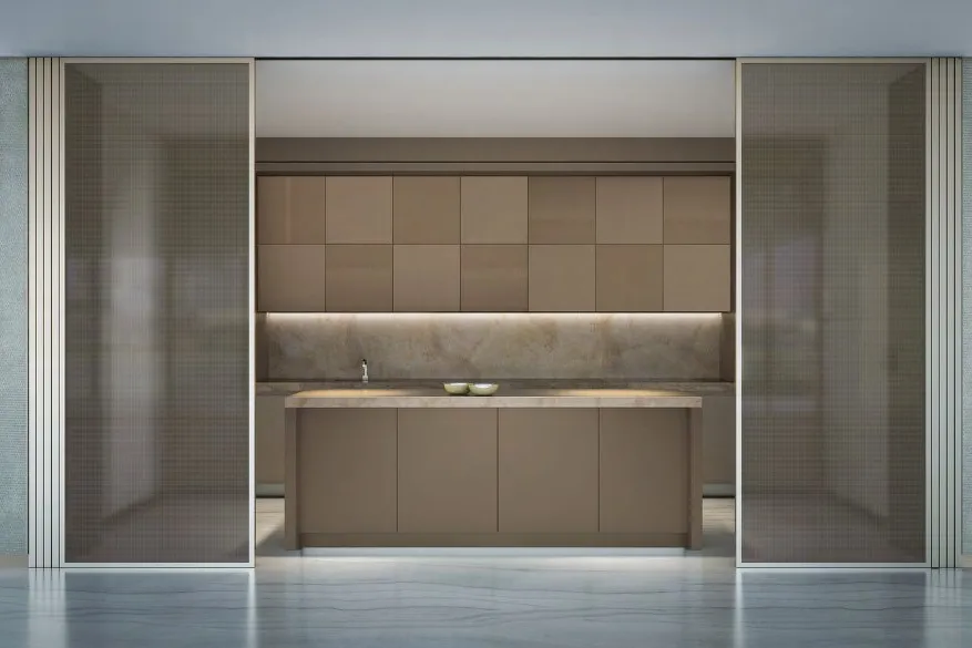 Kitchen with stone island and bronze cabinets behind sliding glass screens