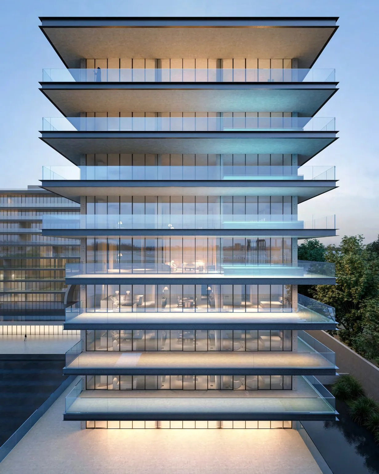 Glass-fronted wing with deep cantilevered terraces glowing at twilight