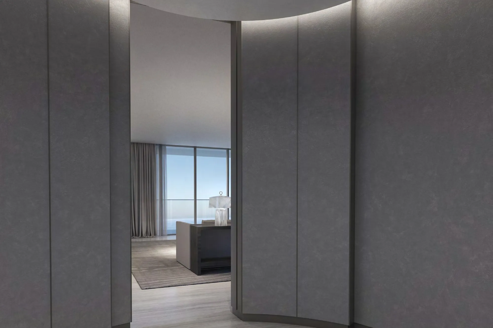 Curved panelled foyer opening onto a living room with sea views