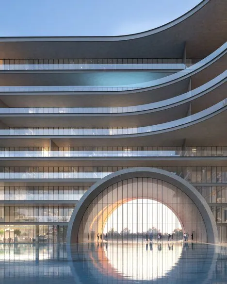 Layered curved balconies and a glowing arch reflected in a pool